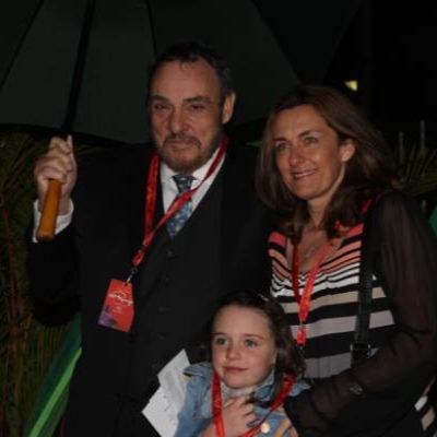 They are at an event posing as John is holding the umbrella.